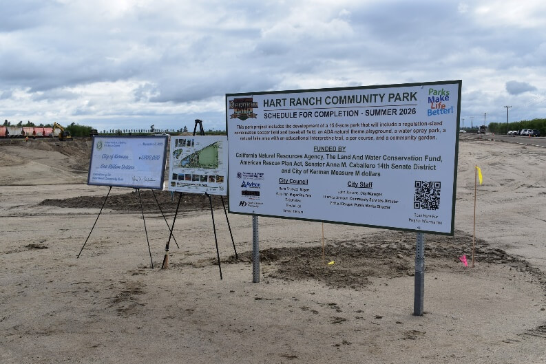 Photo displays signage with a map and project details for Hart Ranch Park in Kerman