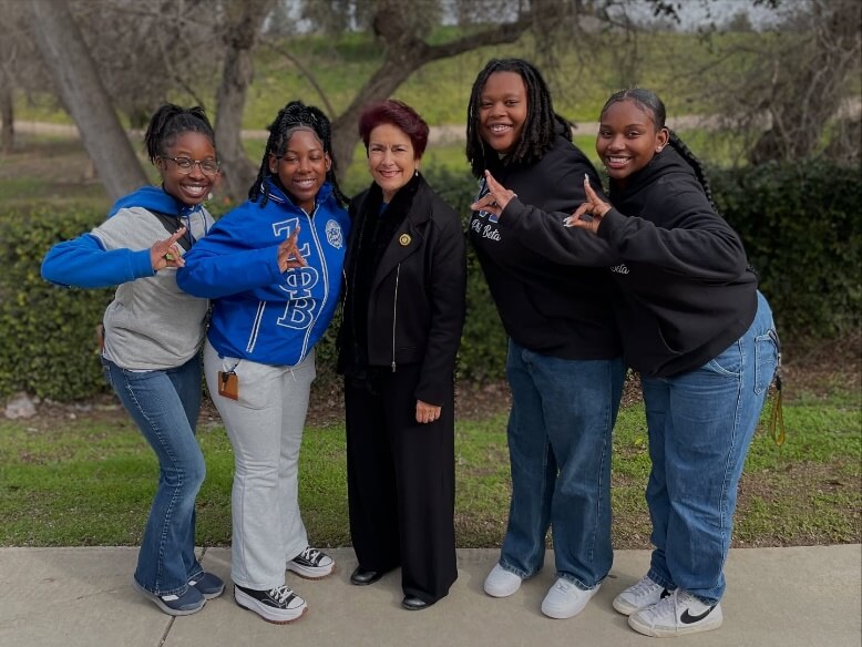 Senator Anna Caballero stands with four members of Zeta Phi Beta Sorority, Inc. at Fresno State.